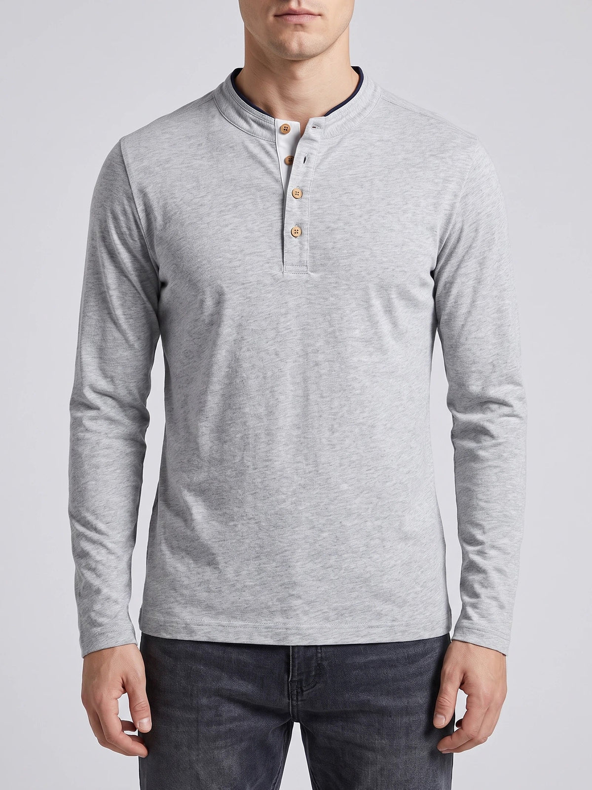 Man wearing a White Slim-Fit cotton long-sleeve Henley shirt while standing on a sunlit garden patio.
