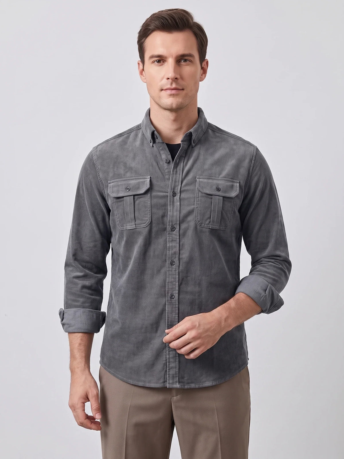 Model wearing a Gray Twill Tweed Shirt with button-flap chest pockets in a wood-paneled library.